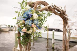 flowers on drift wood arbor