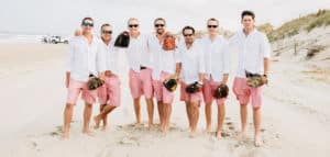 Grooms play catch on the beach